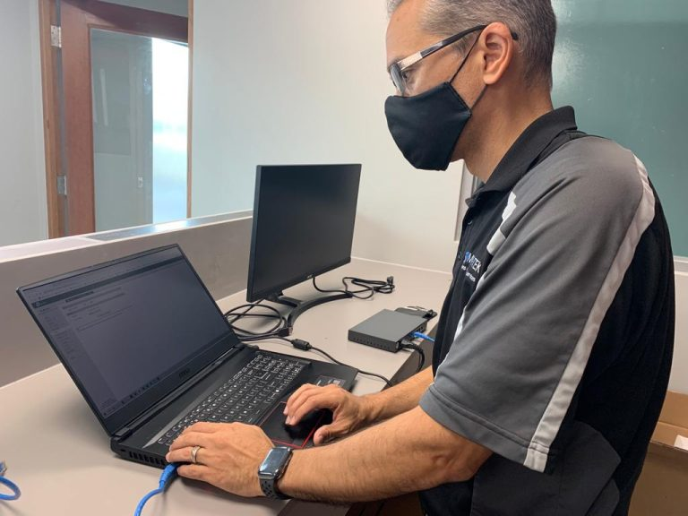 Mor@tek technician configuring a laptop workstation