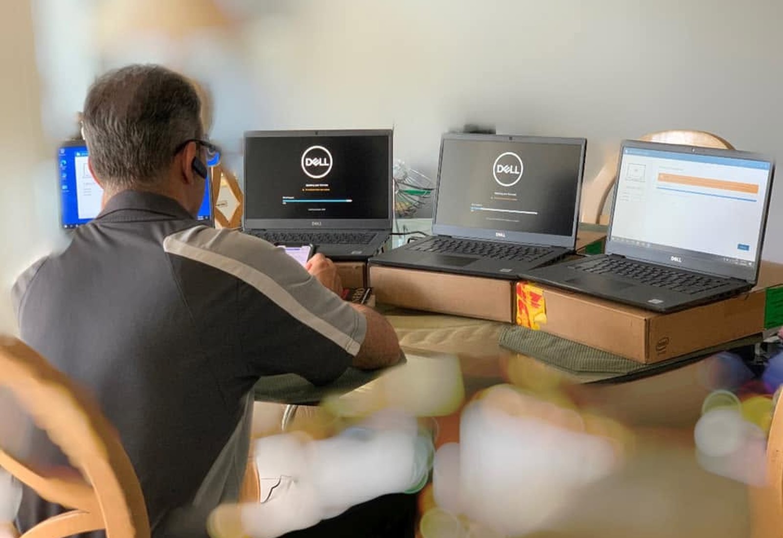Mor@tek technician configuring business laptops