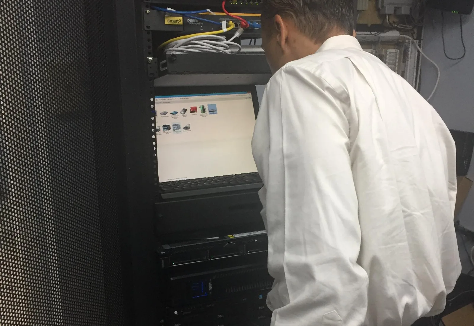 Mor@tek technician working on server rack systems